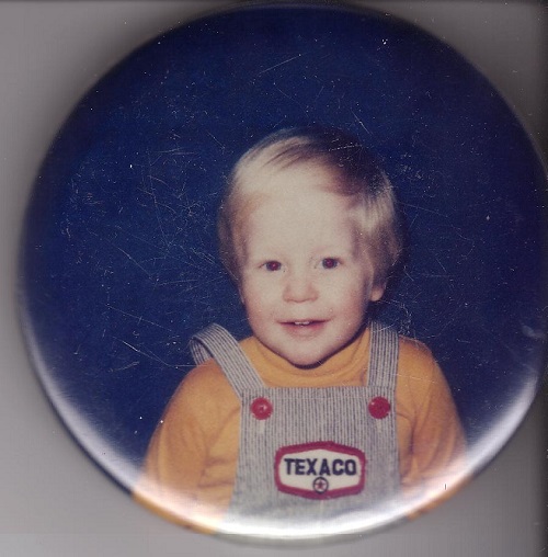 smiling blonde boy in overalls