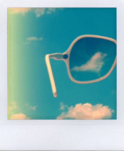 random polaroid of sunglasses and cloud