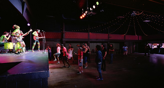 a band playing in a half-empty hall